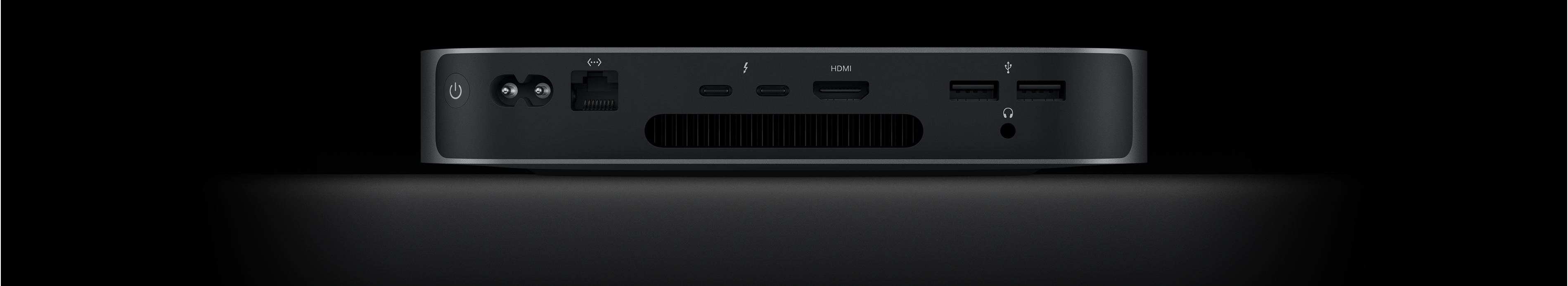 มุมมองด้านหลังของ Mac mini ซึ่งแสดงพอร์ต Thunderbolt 4 จำนวน 2 พอร์ต, พอร์ต HDMI, พอร์ต USB-A จำนวน 2 พอร์ต, ช่องต่อหูฟัง, พอร์ต Gigabit Ethernet, พอร์ตจ่ายไฟ และปุ่มเปิด/ปิด